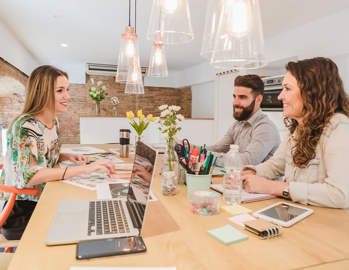cheerful-team-working-with-papers-gadgets-min