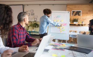 creative-group-discussing-ideas-project-boardroom-min