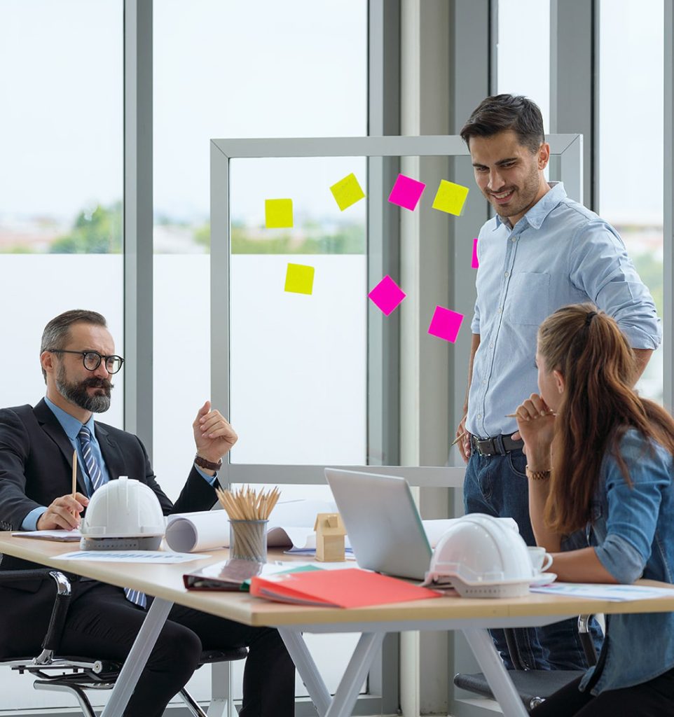 team-multiethnic-architects-working-construction-plans-meeting-room-min